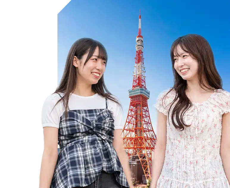Two women laughing together with Tokyo Tower in the background